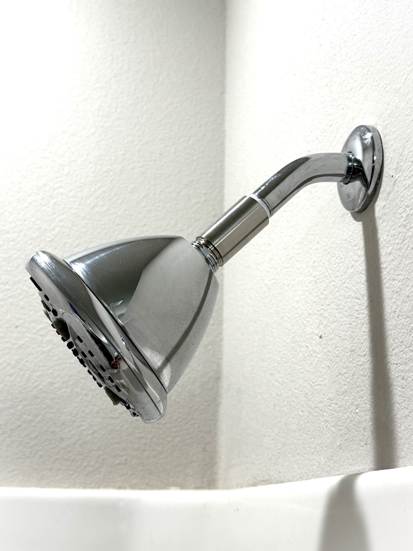 MagSert Shower Extender installed between the shower arm and the showerhead